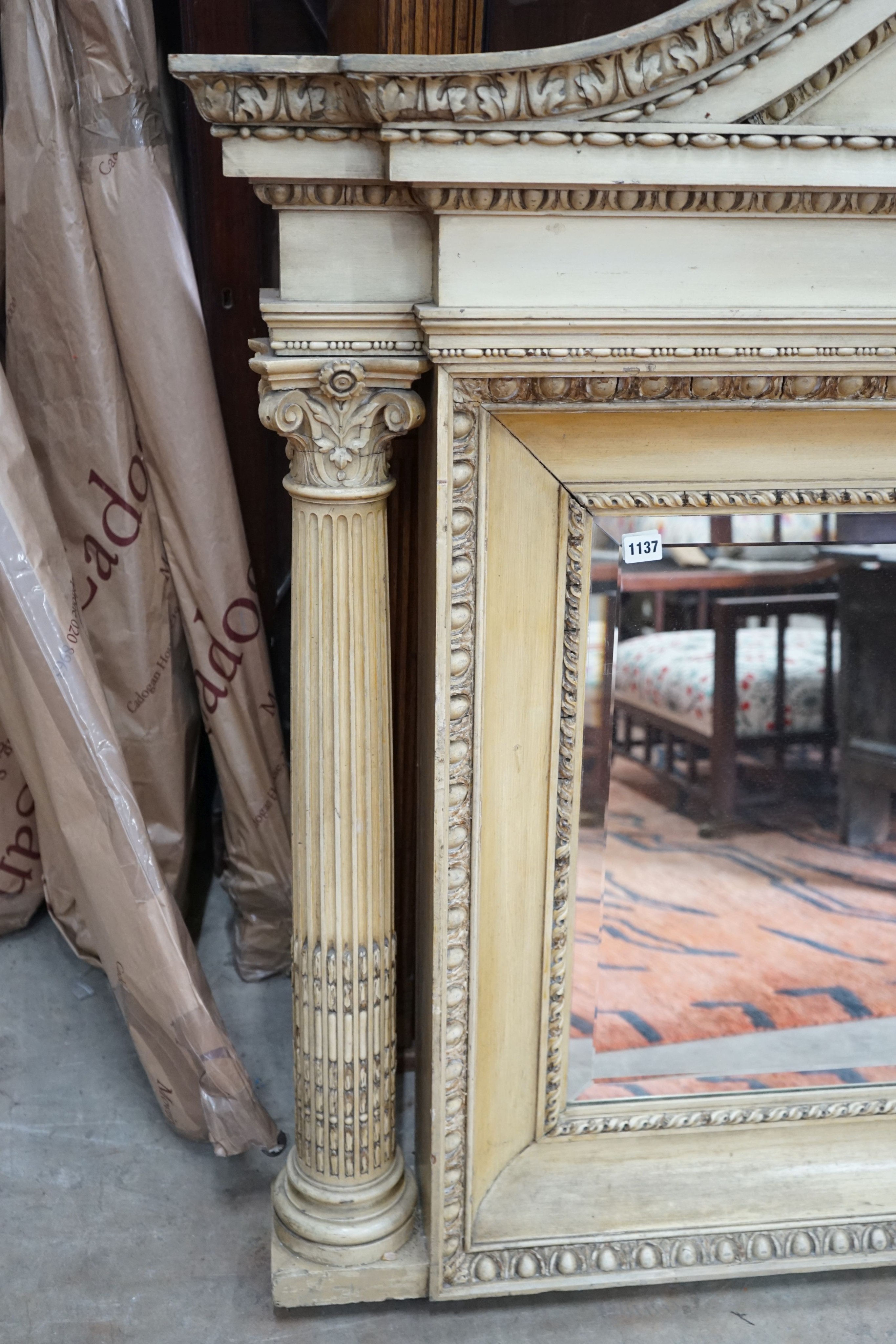 A George III style painted wood and gesso overmantel mirror with rectangular bevelled plate flanked by Corinthian columns, width 152cm, height 122cm